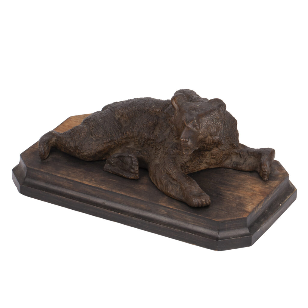 cast iron sculpture of a lying Russian bear attributed to Nikolai Lieberich on wooden base