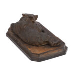 cast iron sculpture of a lying Russian bear attributed to Nikolai Lieberich on wooden base