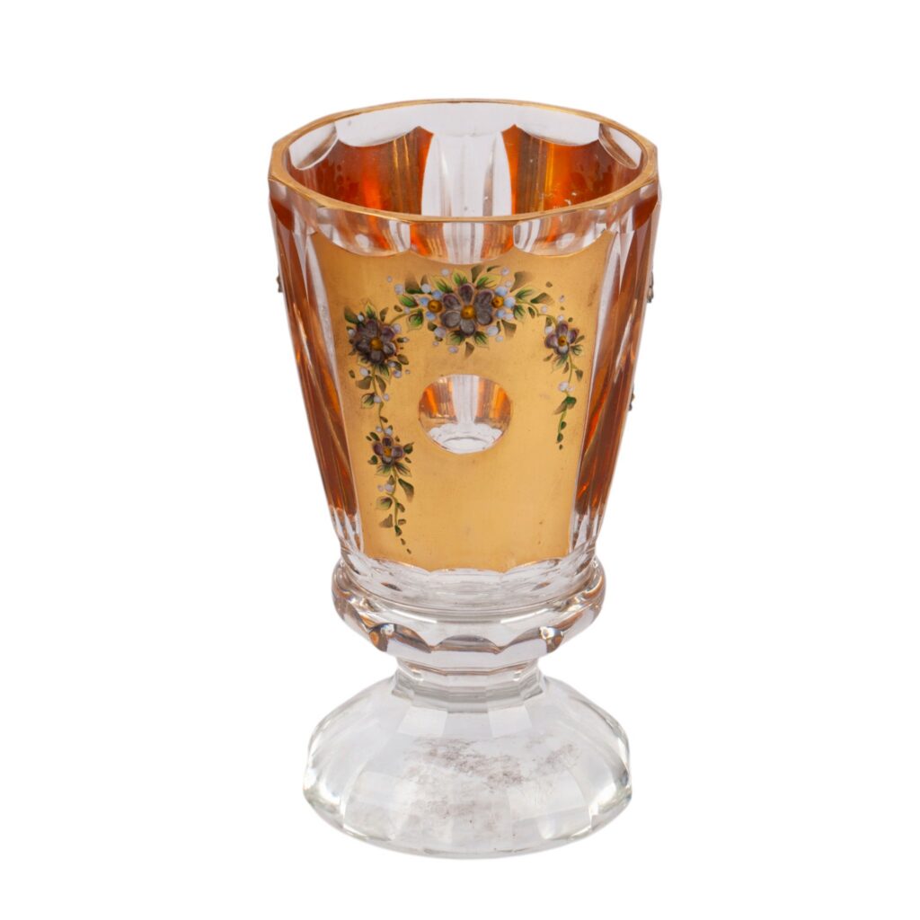 Amber-stained faceted glass goblet with gilt band and enamel floral garlands